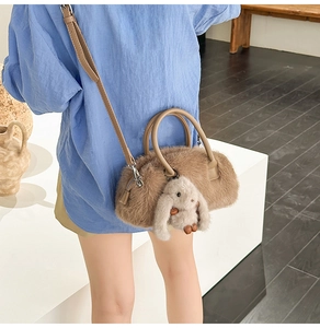 Detailed back view of a fuzzy brown barrel crossbody bag featuring a cute white bunny charm