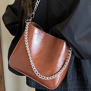 Minimalist brown faux leather bucket bag with chunky silver chain strap for women