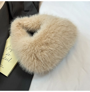 Detail of plush beige faux fur scarf texture on minimalist fashion background