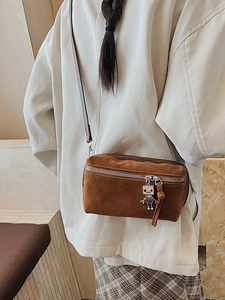 Vintage brown suede crossbody box bag with cute silver robot charm shown on a model