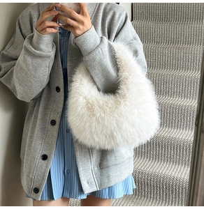 Close-up of fluffy white faux fur hobo bag showing soft texture and plush material