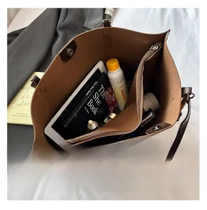 Top view of brown large tote bag showing spacious interior compartments for tablets and books