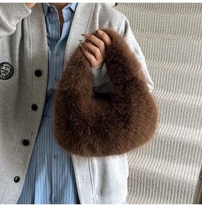 Detail of soft dark brown faux fur handbag showing plush texture and ring handle design