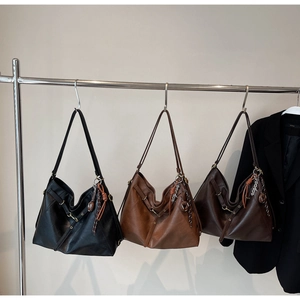 Detailed view of large tote bags in black, caramel, and coffee brown leather options