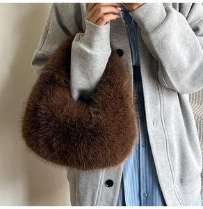 Detail view of deep brown plush hobo bag with thick faux fur texture and integrated handle