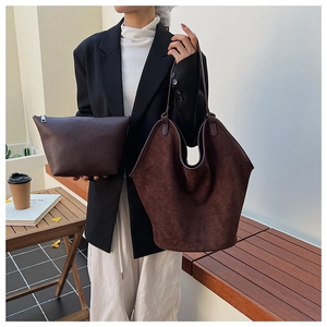 Detail of vintage dark brown tote bag set with matching zipper pouch and suede texture
