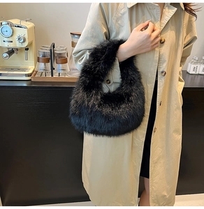 Detail of fluffy black faux fur plush handbag styled with a long beige trench coat