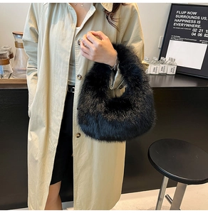 Detail of a chic black faux fur handbag held by a model in a trendy cafe setting
