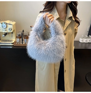 Gray faux fur hobo bag shown in a cozy cafe setting with warm natural lighting