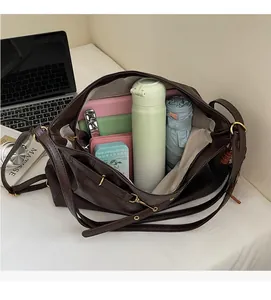 Detail view of large brown commute tote bag showing spacious interior with daily essentials
