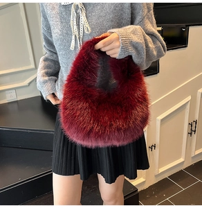 Detail of burgundy faux fur handbag showing thick fluffy texture and chic retro design