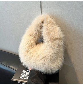 Detailed texture of the beige plush faux fur handbag with soft and fluffy material