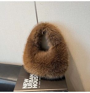 Detailed close-up of plush brown faux fur texture on a stylish autumn winter tote bag