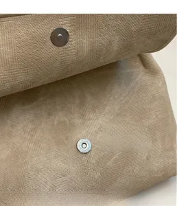 Makroaufnahme des Magnetverschlusses und des strukturierten Stoffes dieser khakifarbene Tasche