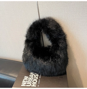 Detailed close-up showing the soft texture of a black faux fur hobo handbag on a prop