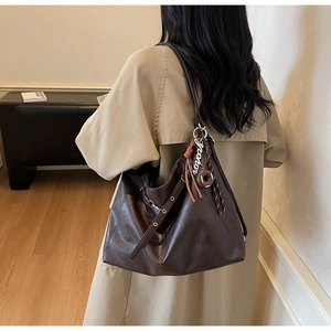 Brown large capacity tote bag shown from behind to highlight stylish drape and scale