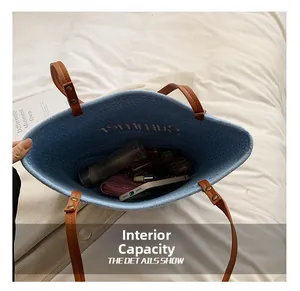 Top view of blue straw tote bag showing large interior capacity with personal items