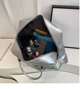 Spacious interior of the metallic silver tote bag showing pockets and daily essentials