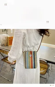 Detail of bohemian woven mini crossbody bag with colorful stripes and vintage button