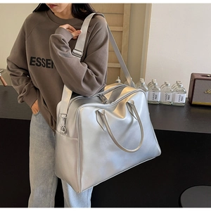 Silver large capacity travel tote bag with metallic finish and wide shoulder strap