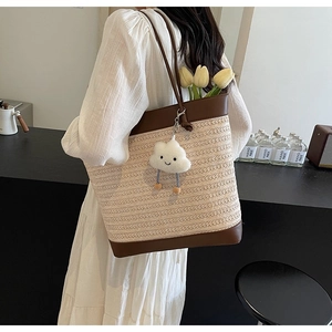 Large summer woven tote bag with brown leather trim and a cute cloud charm on shoulder