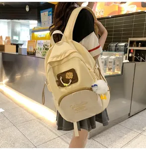 Creamy yellow lightweight backpack with flower patch and cute plush duck pendant detail