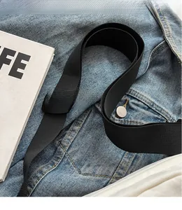Detail of adjustable black nylon shoulder strap with plastic buckle for crossbody bags