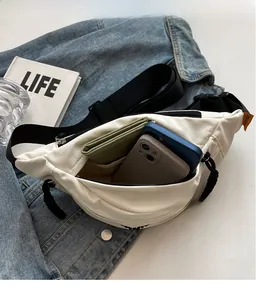 Internal view of a white nylon crossbody bag showing space for two phones and a wallet
