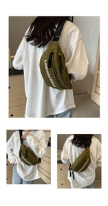 Close-up of military green canvas chest bag with adjustable strap and artistic lettering