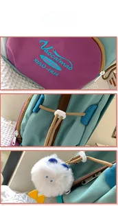 Close-up of colorful canvas backpack showing embroidery logo, drawstring and plush charm