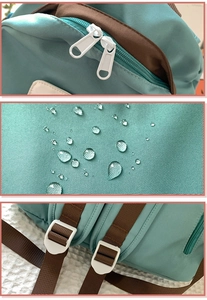 Detail showing waterproof plain weave fabric with water droplets and durable dual zippers