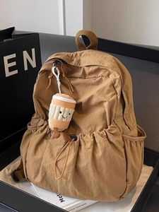 Japanese style khaki nylon backpack with large pockets and cute coffee plush charm