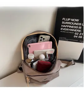 Detail showing the large internal capacity of the khaki travel backpack with daily essentials