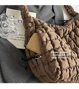 Detailed view of the brown puffer bag side pocket for convenient small item storage