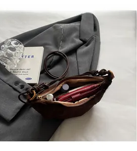 Macro shot of large capacity dark brown crossbody bag interior with zipper closure