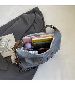 Detailed interior of a grey suede tote bag showing space for tablets and umbrellas