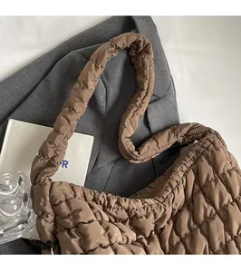 Detail shot of the brown quilted cloud bag with padded strap and square puff texture