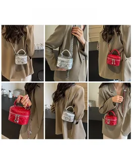 Detailed views of quilted mini box bags in silver and red with heart charms