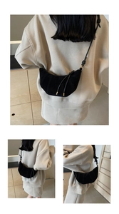 Detailed view of black crescent crossbody bag in premium suede with fine stitching details