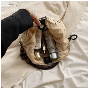 Interior view of straw bucket bag showing large capacity for umbrella and cosmetics