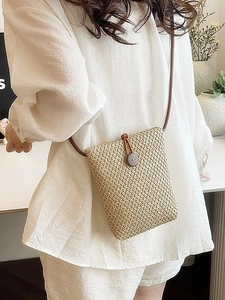 Minimalist straw crossbody bag with wood button and brown strap for summer fashion