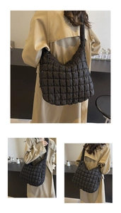 Three-way view of a large black quilted puffy cloud bag worn on shoulder in minimalist setting