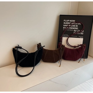 Three minimalist suede crescent bags in black, mocha brown and burgundy colors