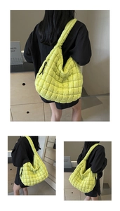 Detail of light green quilted bubble tote bag featuring spacious design and wide shoulder strap