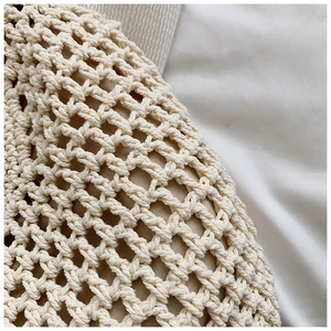Detailed macro view of the beige hand-woven hollow knit texture and fabric lining