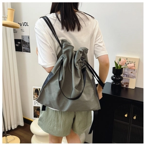 Detail of grey waterproof drawstring tote bag showing adjustable straps and large capacity