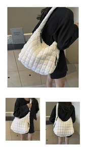 Detailed macro view of white quilted puffer cloud bag with square pattern stitching
