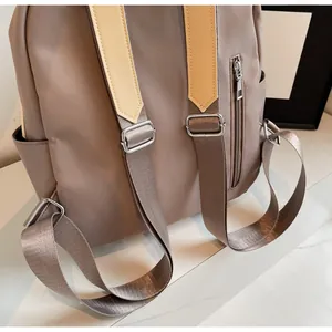 Macro view of the nylon backpack back with shoulder straps and silver metal buckles