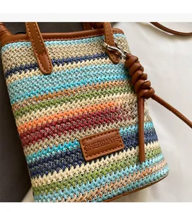Close-up of colorful striped straw woven texture with premium brown leather strap detailing