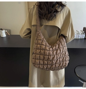 Detailed back view of a brown quilted cloud bag showing soft padded texture and capacity